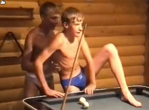 Lads play around in a log cabin